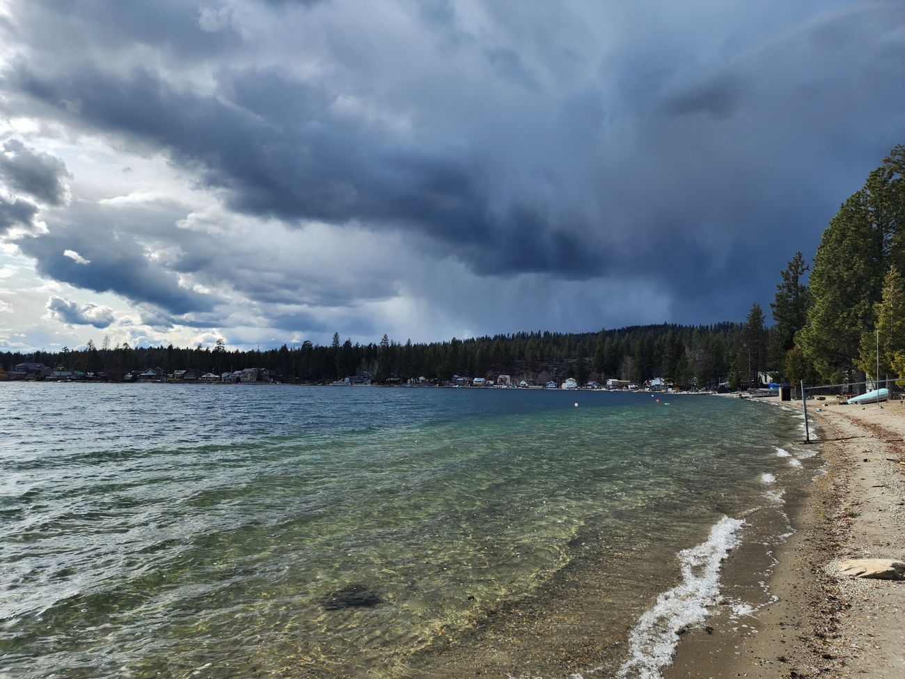 Storm clouds over the lake and shoreline homes